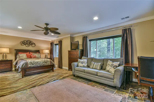 a bedroom with a large bed and a couch