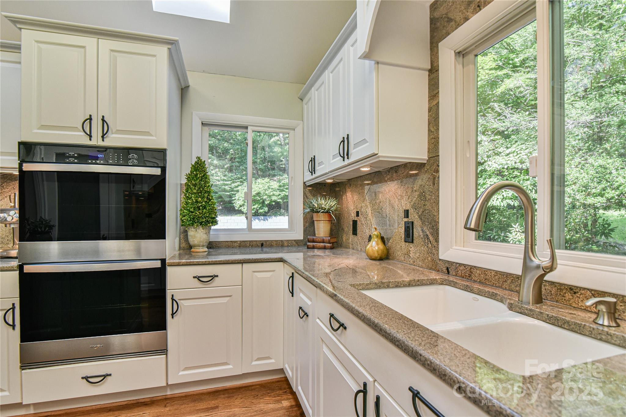 409 North Fork Road Black Mountain, NC 28711 - Photo 7 of 48 a kitchen with granite countertop a stove and a sink