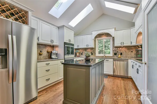 a kitchen with white cabinets and white appliances