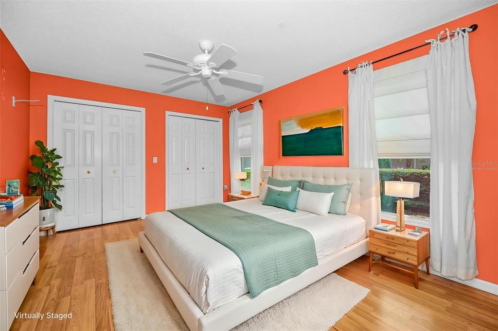 11917 Hadleigh Way Trinity, FL 34655 - Photo 31 of 84 a bedroom with a large bed and a chandelier