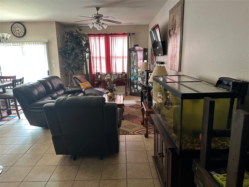 701 Parkplace Ridge Princeton, TX 75407 - Photo 5 of 13 a living room with furniture a flat screen tv and a window