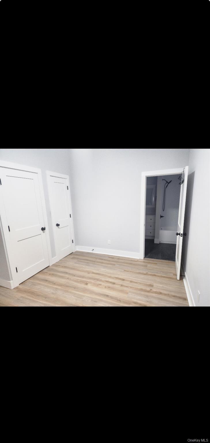 18 Carman Street, Unit 2 Patchogue, NY 11772 - Photo 6 of 11 a view of an empty room with wooden floor
