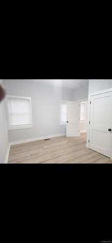 a view of wooden floor and a window