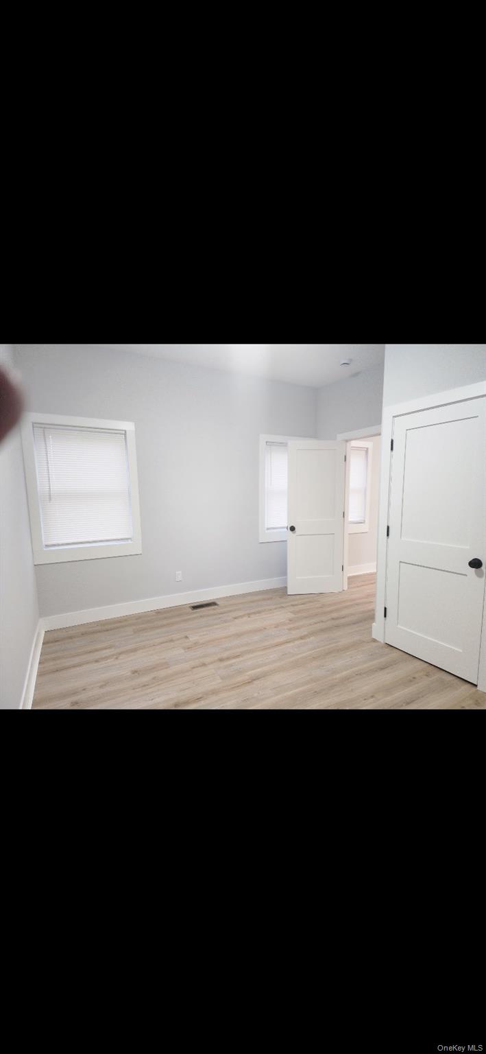 18 Carman Street, Unit 2 Patchogue, NY 11772 - Photo 7 of 11 a view of wooden floor and a window
