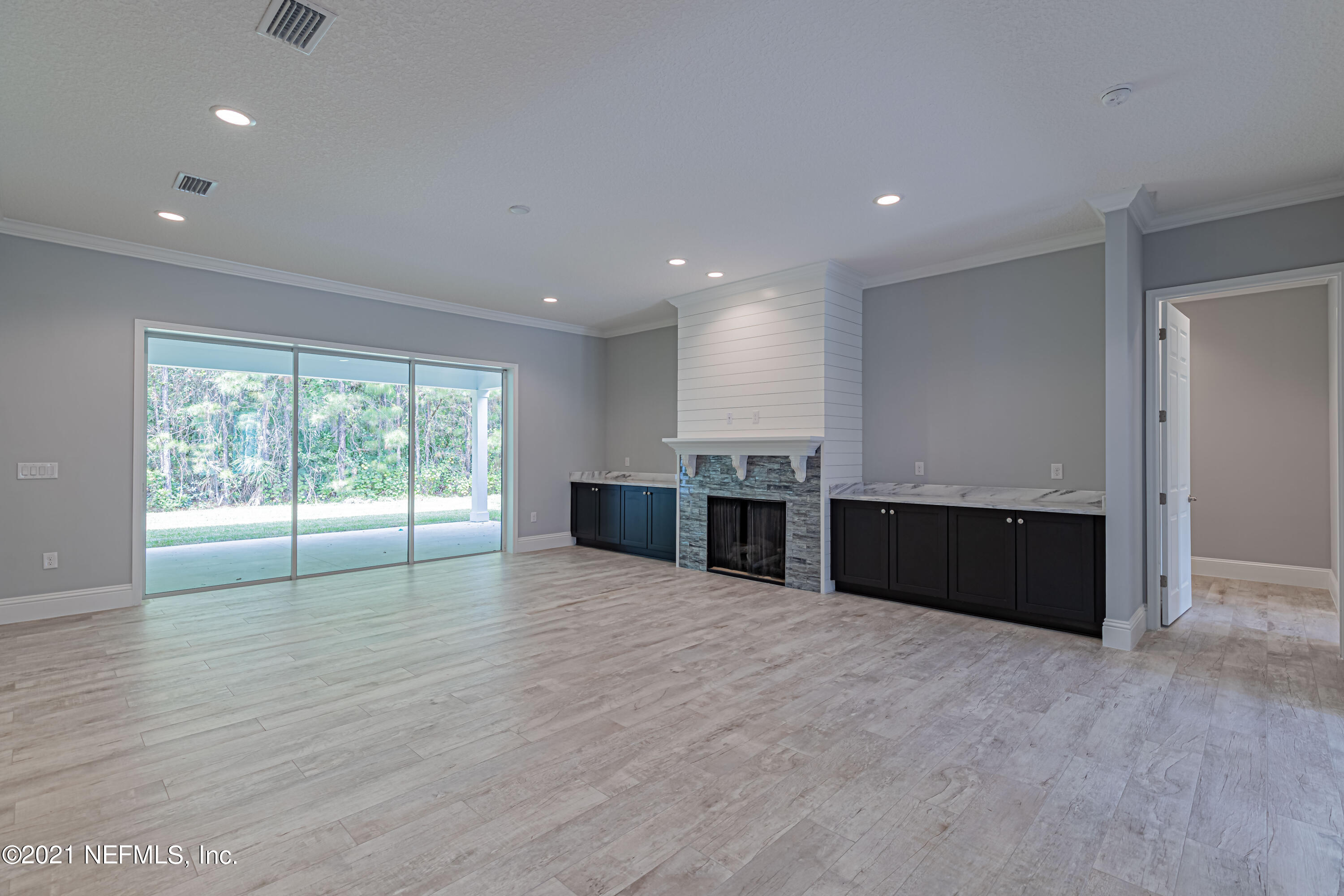 1351 Weaver Glen Road Jacksonville, FL 32223 - Photo 12 of 30 a large kitchen with stainless steel appliances granite countertop a large counter top and a wooden floor