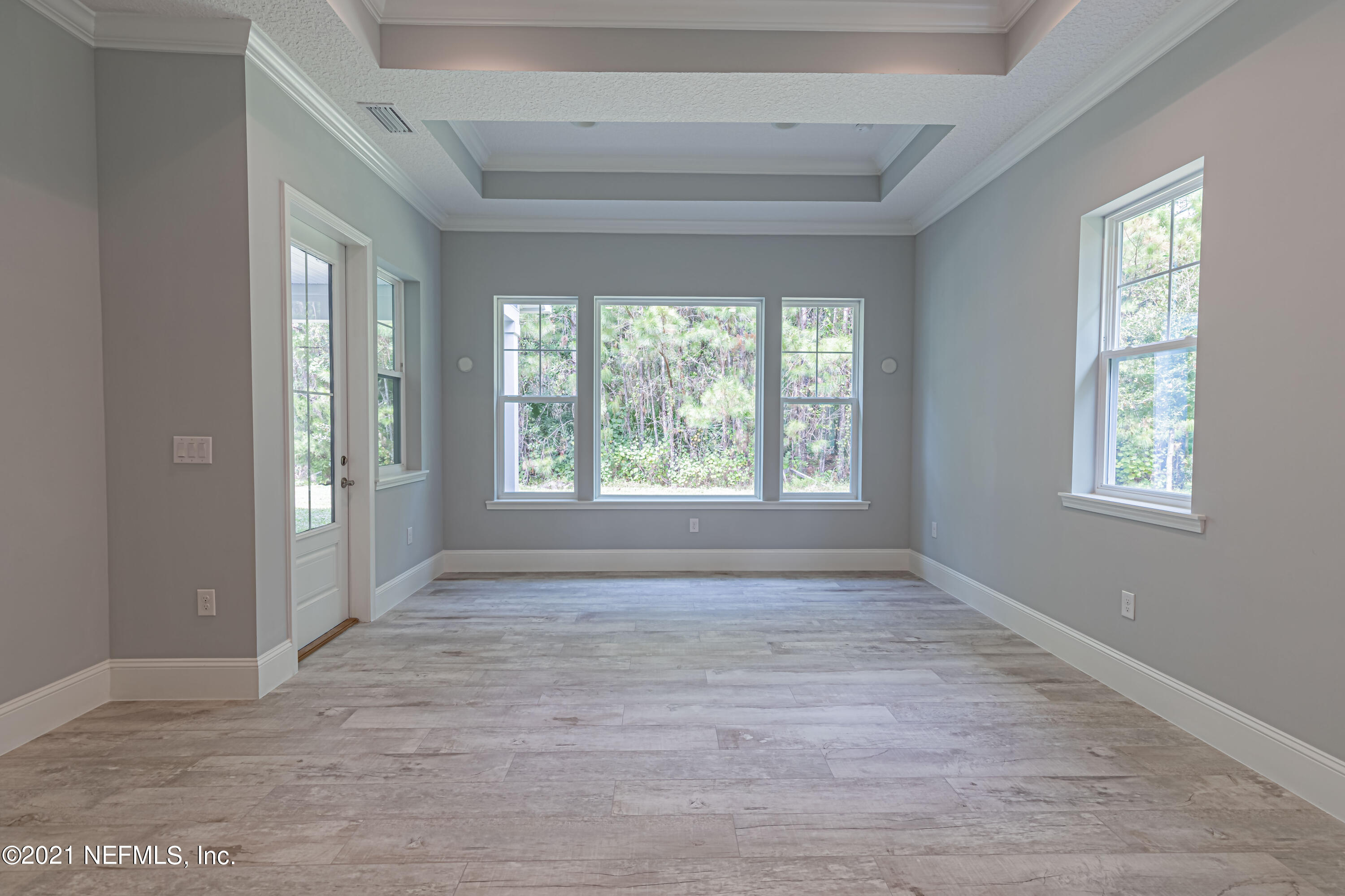 1351 Weaver Glen Road Jacksonville, FL 32223 - Photo 18 of 30 a view of an empty room with wooden floor and a window