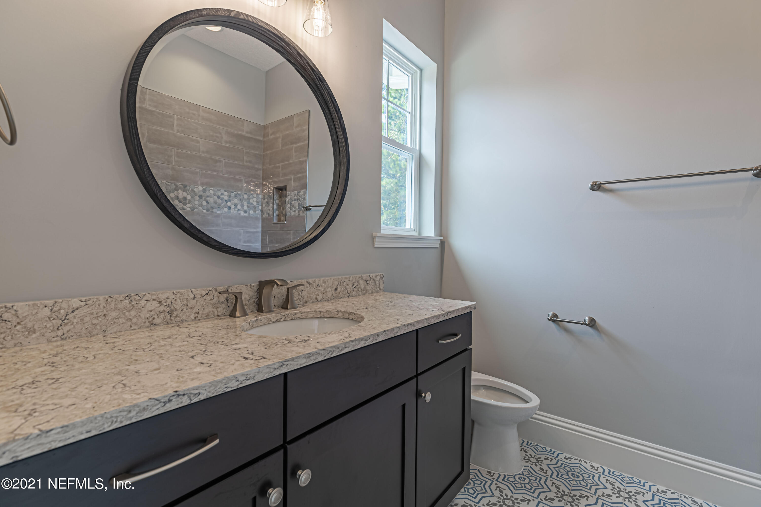 1351 Weaver Glen Road Jacksonville, FL 32223 - Photo 22 of 30 a bathroom with a granite countertop toilet sink and mirror