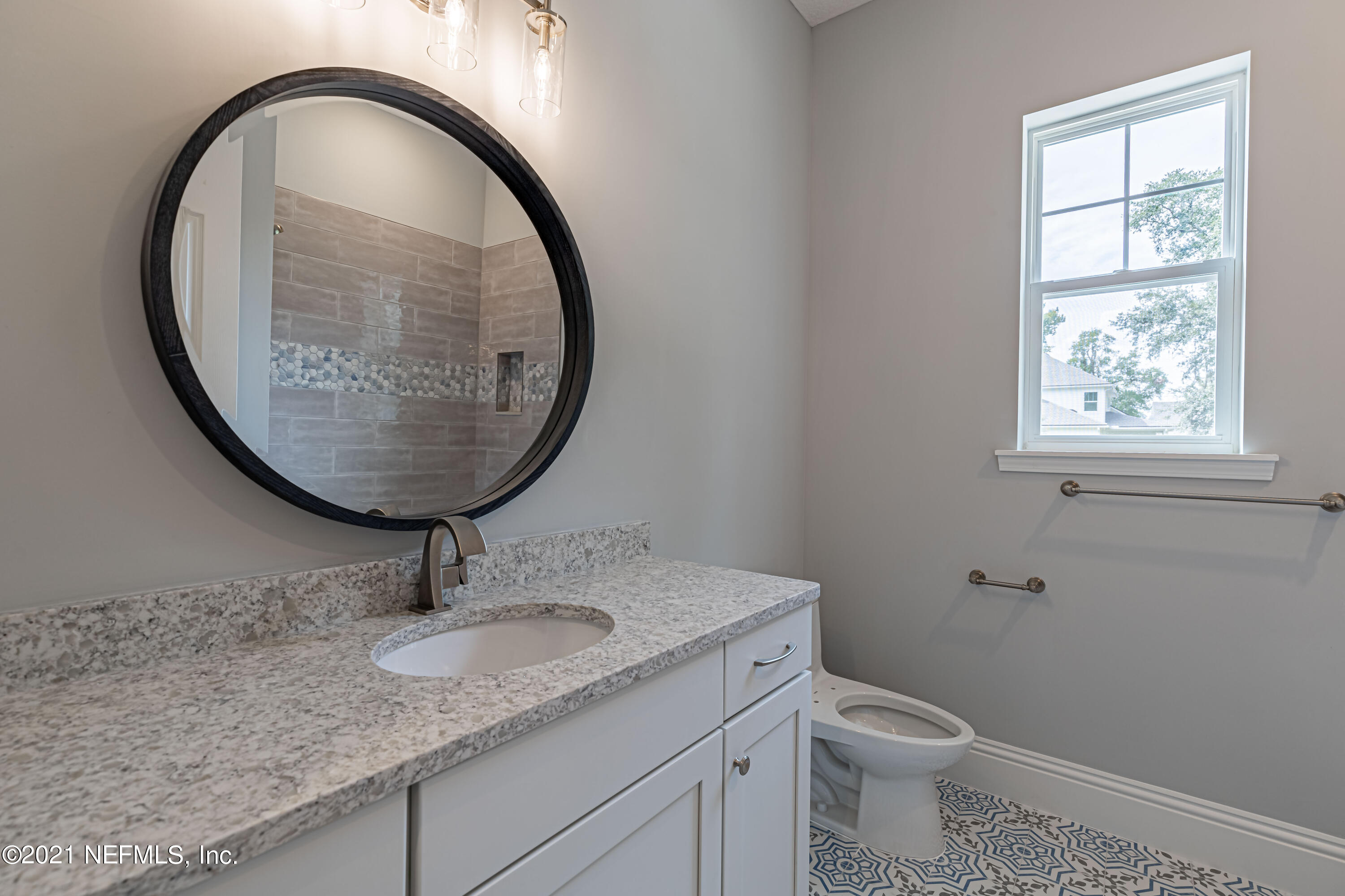 1351 Weaver Glen Road Jacksonville, FL 32223 - Photo 24 of 30 a bathroom with a granite countertop toilet sink and mirror