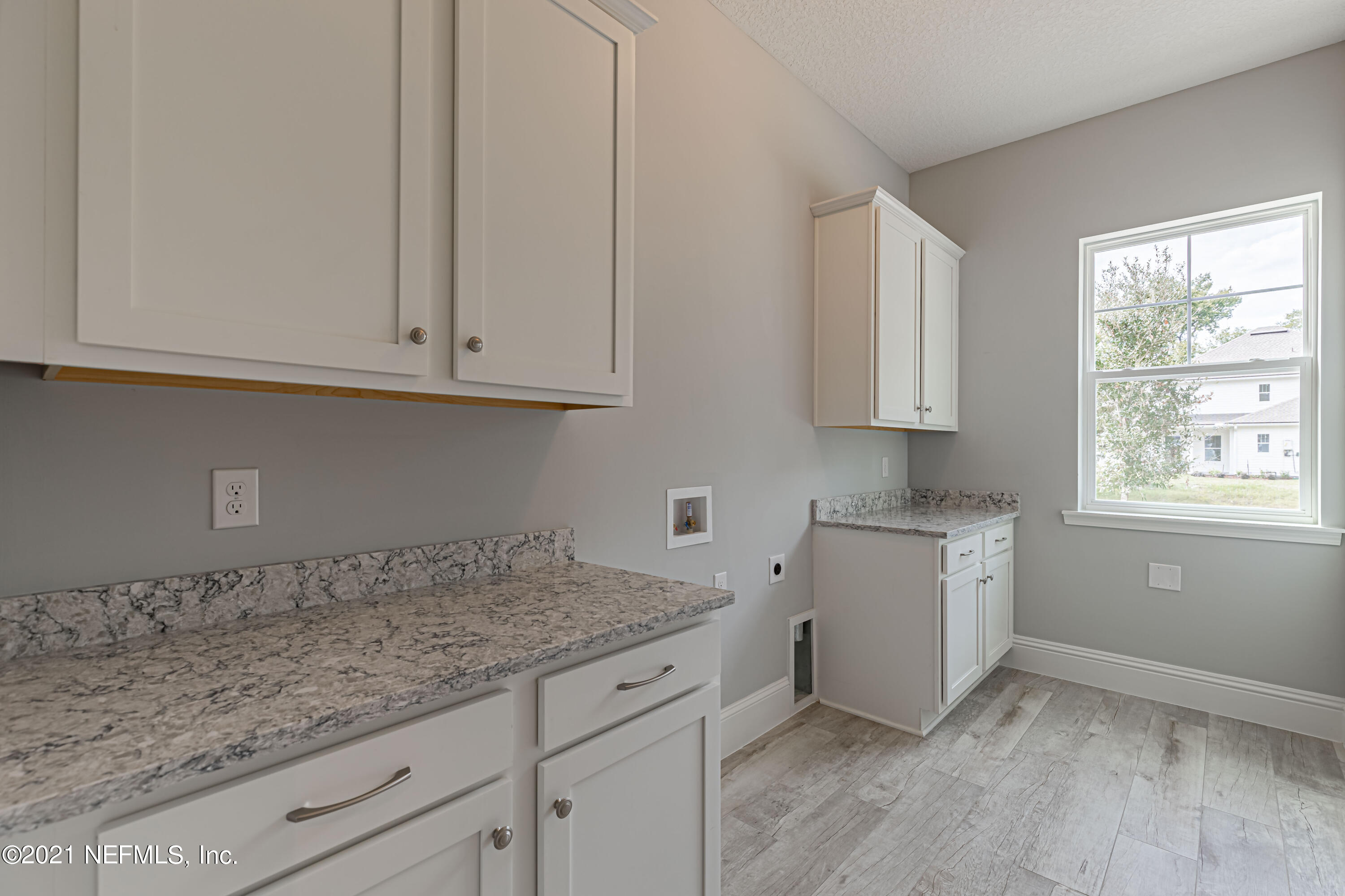 1351 Weaver Glen Road Jacksonville, FL 32223 - Photo 25 of 30 a kitchen with granite countertop white cabinets and a sink