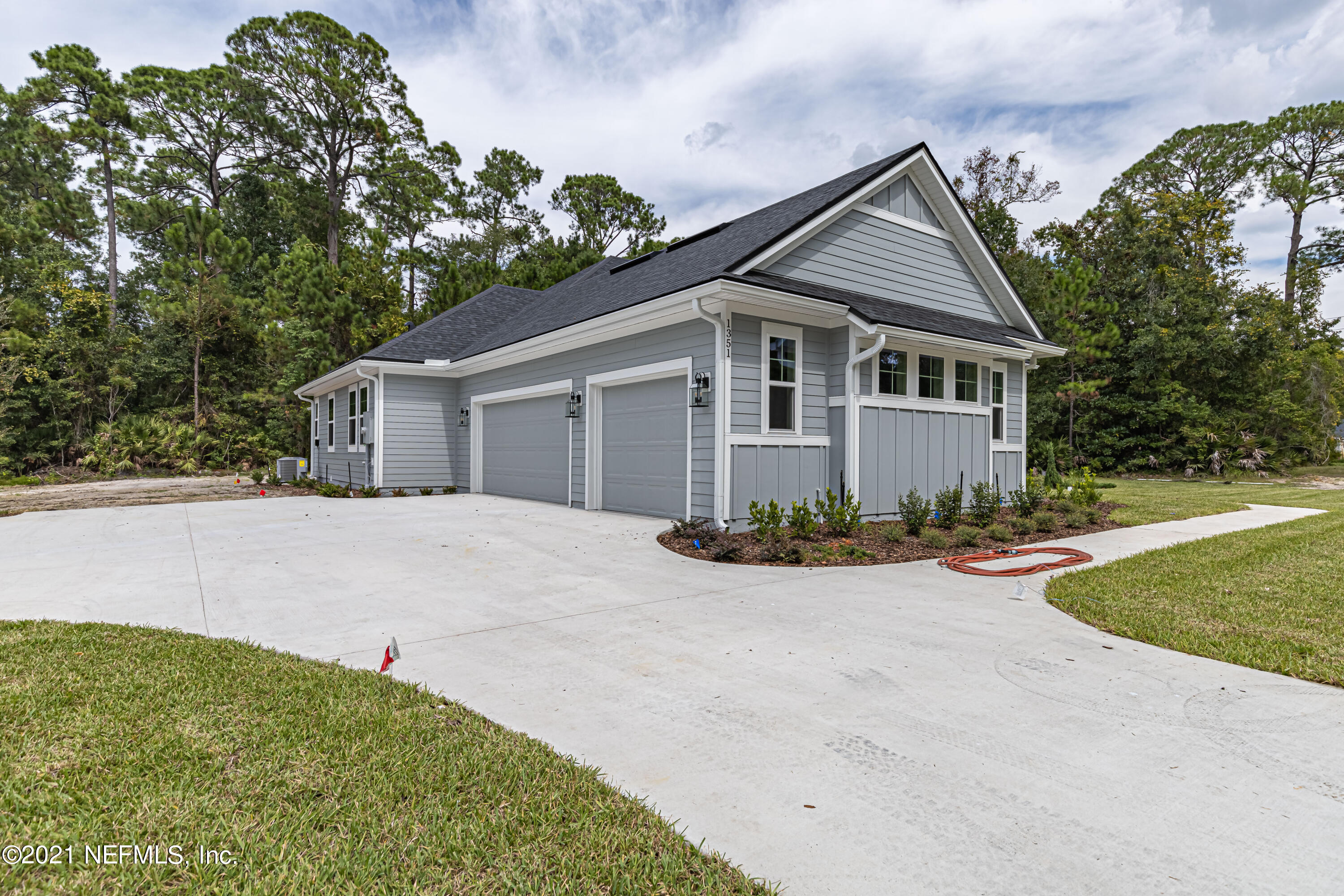 1351 Weaver Glen Road Jacksonville, FL 32223 - Photo 3 of 30 front view of house with a yard and potted plants