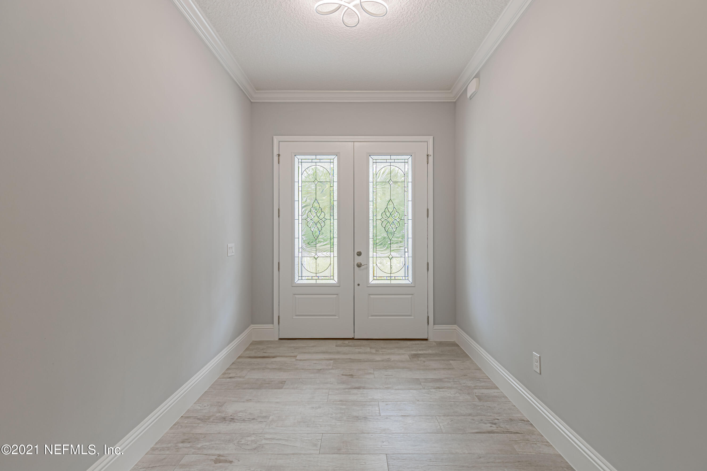 1351 Weaver Glen Road Jacksonville, FL 32223 - Photo 4 of 30 an empty room with wooden floor and windows