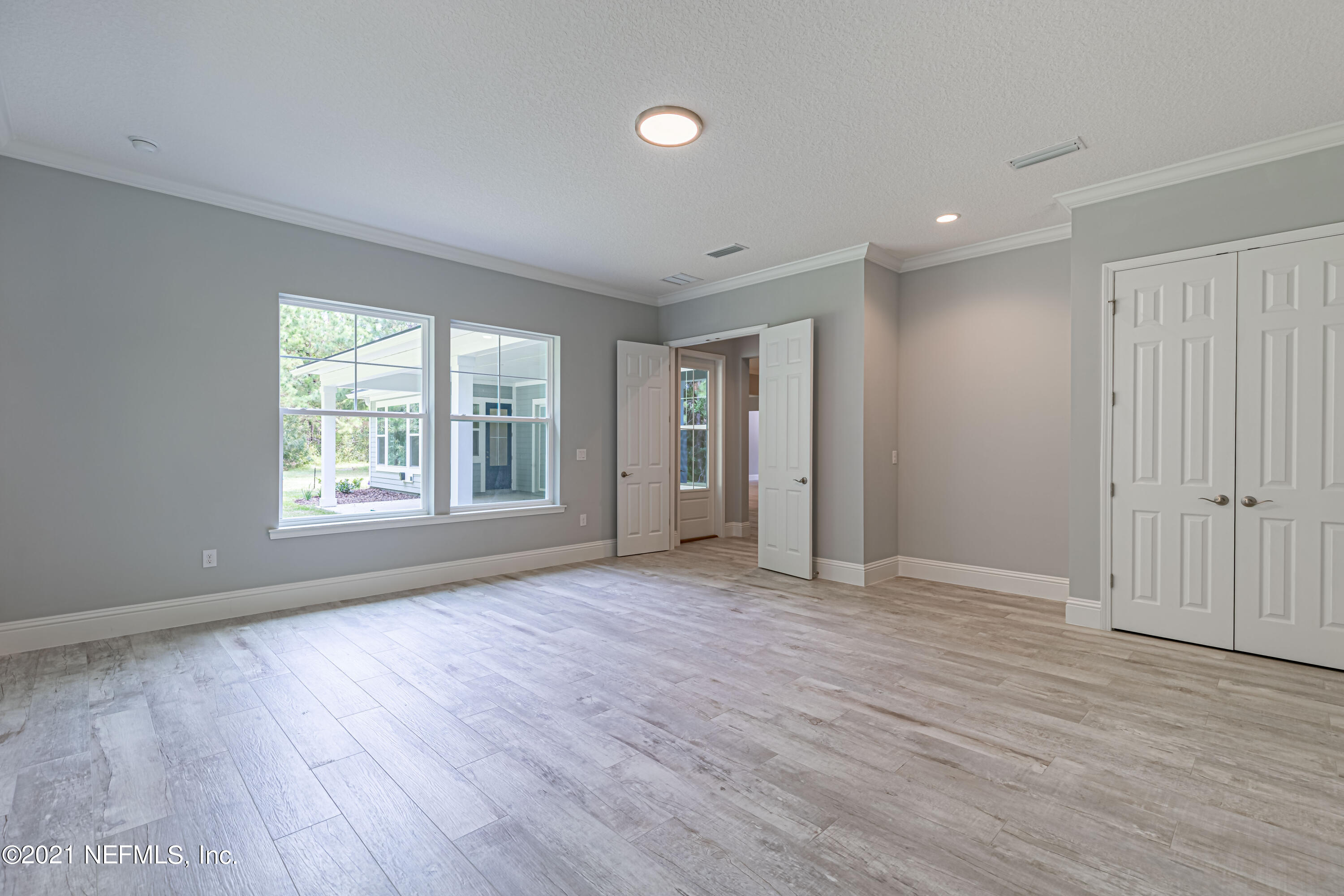 1351 Weaver Glen Road Jacksonville, FL 32223 - Photo 5 of 30 an empty room with wooden floor and windows