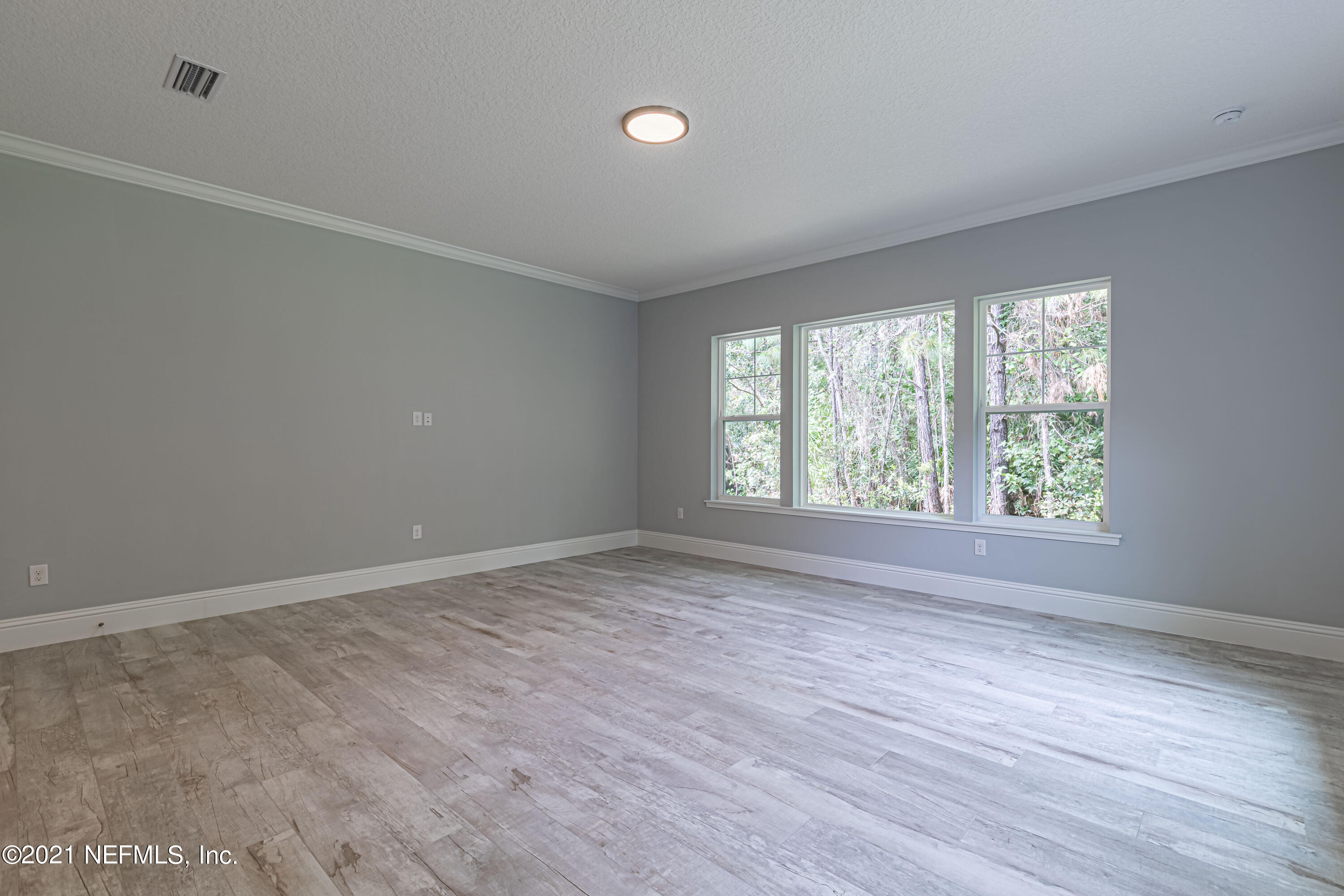 1351 Weaver Glen Road Jacksonville, FL 32223 - Photo 6 of 30 wooden floor in an empty room with a window