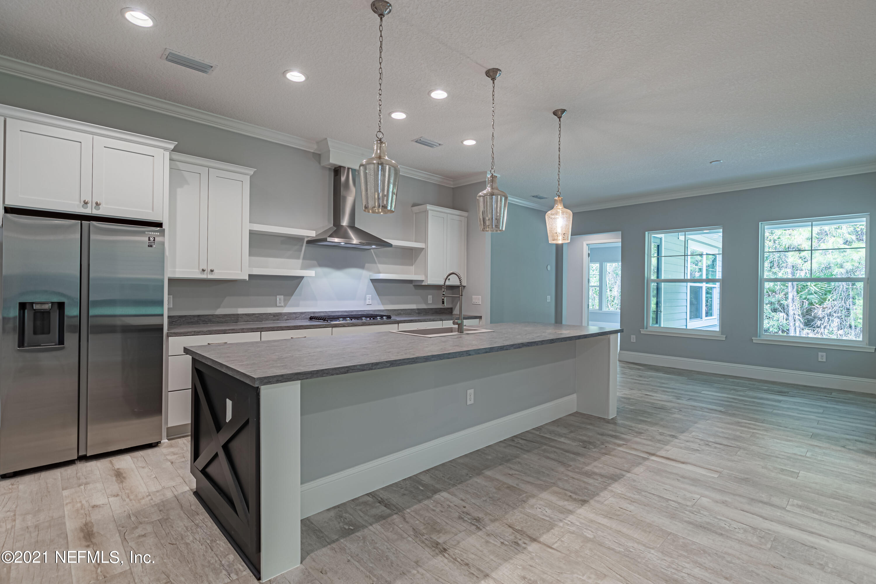1351 Weaver Glen Road Jacksonville, FL 32223 - Photo 8 of 30 a large kitchen with kitchen island a large counter space a sink appliances and cabinets