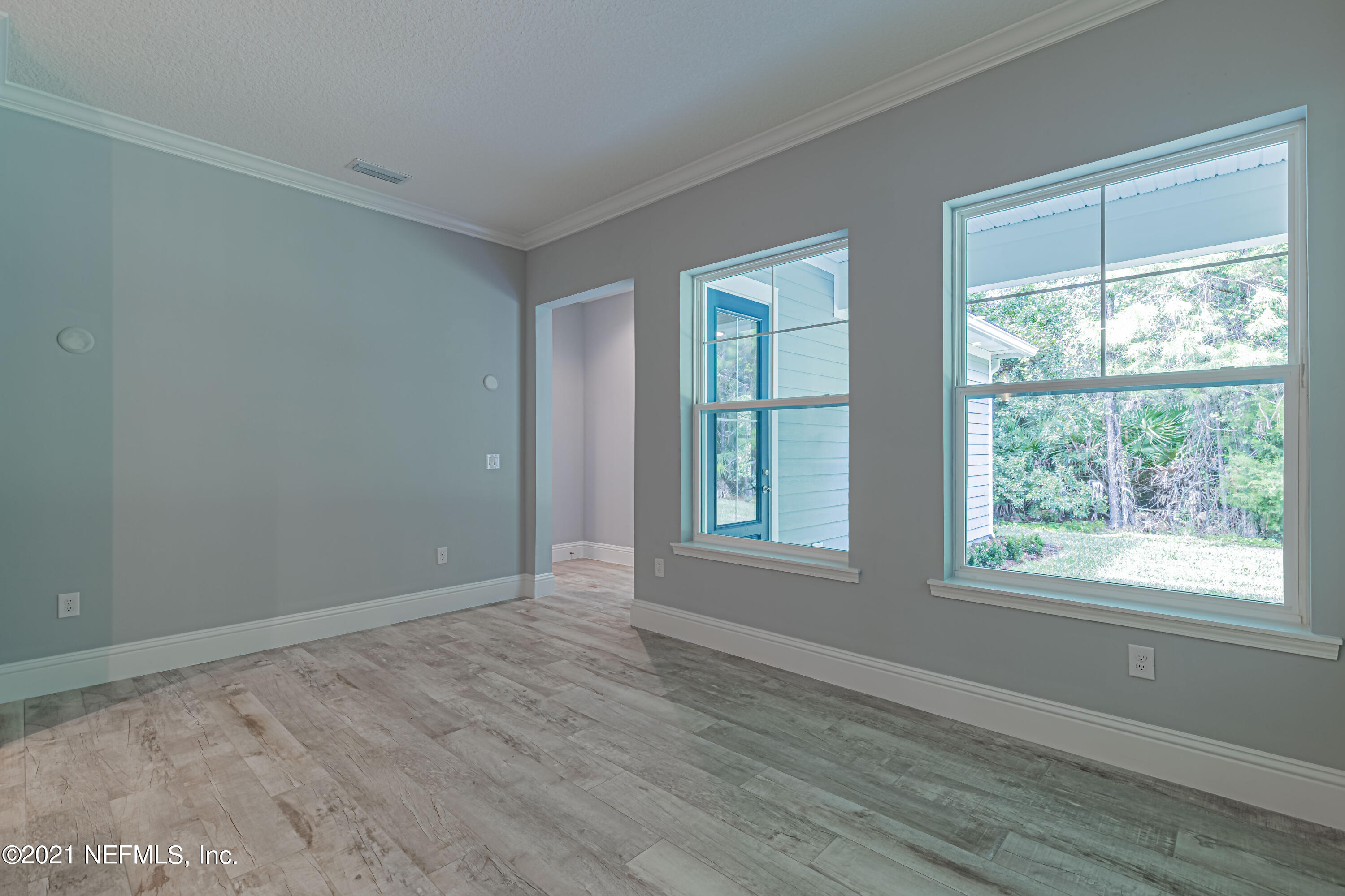 1351 Weaver Glen Road Jacksonville, FL 32223 - Photo 10 of 30 a view of an empty room with wooden floor and a window
