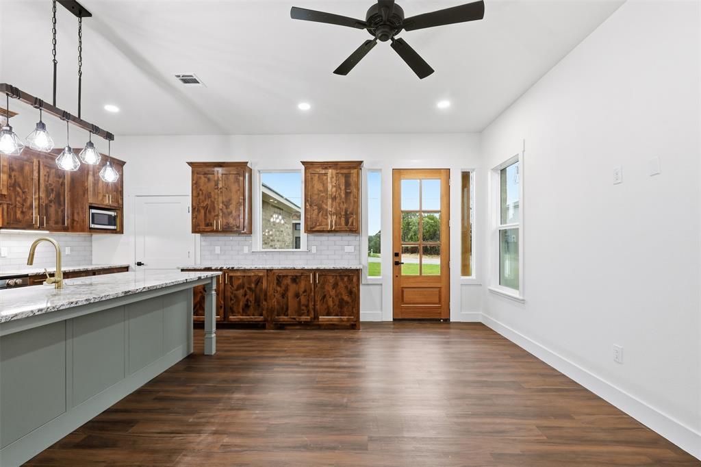 1413 Ridgeview Circle Granbury, TX 76048 - Photo 10 of 35 Open-concept living space featuring wood-finish flooring, a contemporary ceiling fan, and recessed lighting
