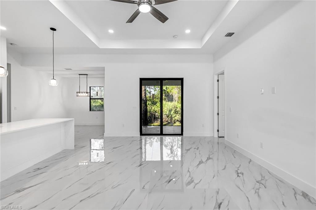 2113 Grayson Avenue Alva, FL 33920 - Photo 4 of 25 Unfurnished room featuring a tray ceiling, recessed lighting, a ceiling fan, and light marble finish flooring