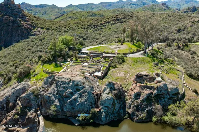 a view of a swimming pool with a yard and mountain view
