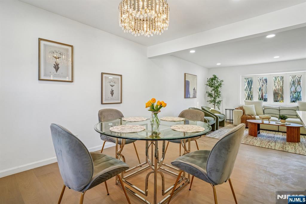 127 Village Circle West Paramus, NJ 07652 - Photo 11 of 46 a view of a dining room with furniture and a potted plant