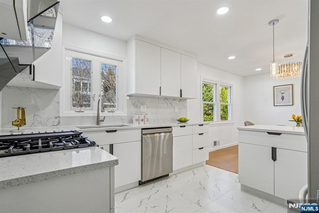 127 Village Circle West Paramus, NJ 07652 - Photo 13 of 46 a kitchen with a sink stove and window