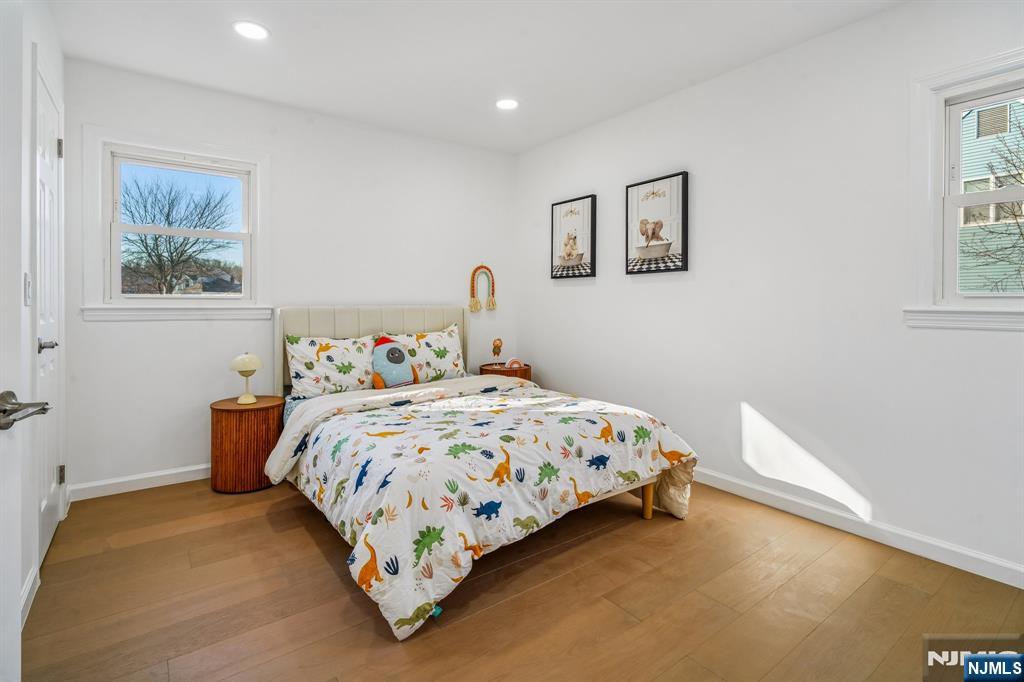 127 Village Circle West Paramus, NJ 07652 - Photo 14 of 46 a bedroom with a bed and a painting on the wall