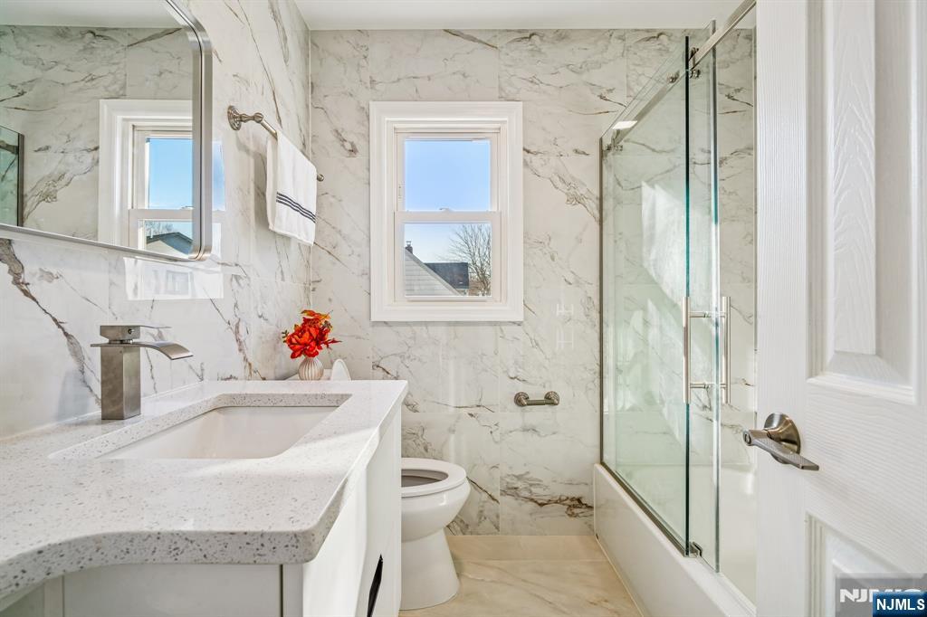 127 Village Circle West Paramus, NJ 07652 - Photo 21 of 46 a bathroom with a sink toilet vanity and shower