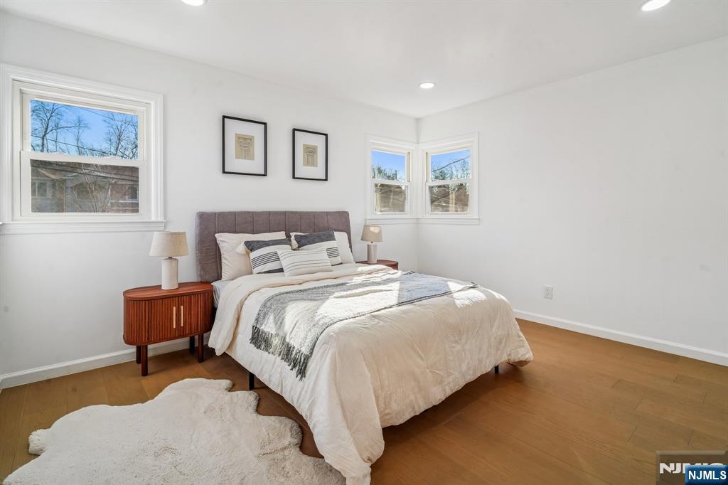 127 Village Circle West Paramus, NJ 07652 - Photo 22 of 46 a large bed sitting in a bedroom next to a window with potted plant