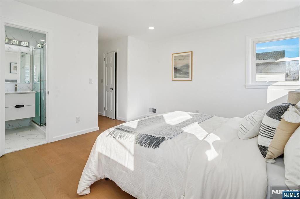 127 Village Circle West Paramus, NJ 07652 - Photo 24 of 46 a bedroom with a bed and a window