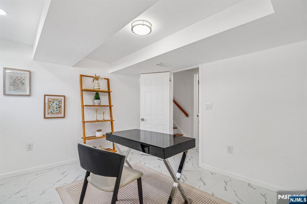 127 Village Circle West Paramus, NJ 07652 - Photo 28 of 46 a view of a workspace with furniture and a potted plant