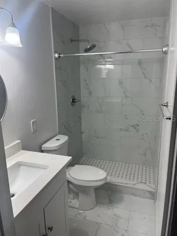 a bathroom with a toilet a sink and shower