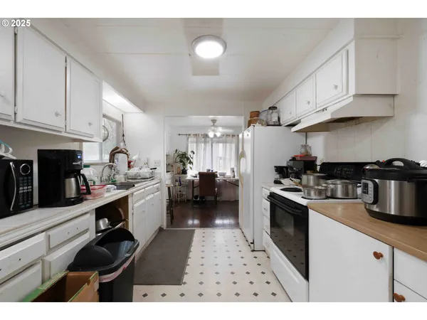 a kitchen with cabinets and wooden floor