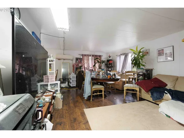 a living room with lots of furniture and a painting