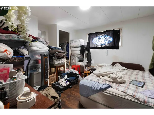 a bedroom with bed and a tv