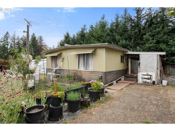 a backyard of a house with table and chairs