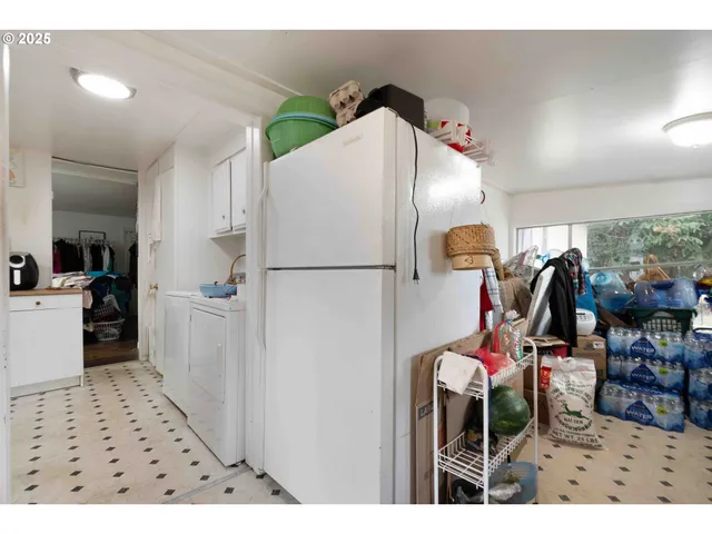 a utility room with closet a sink and a wooden floor