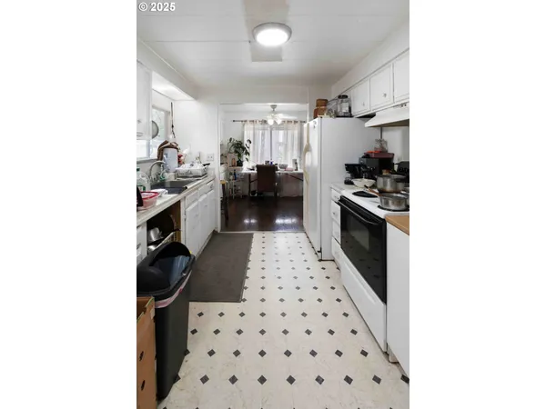 a kitchen with sink cabinets and stainless steel appliances