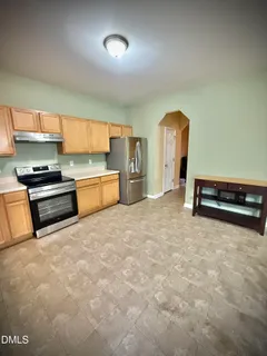 a kitchen with stainless steel appliances granite countertop a refrigerator sink and cabinets