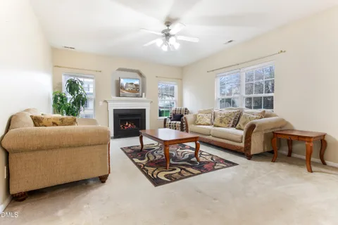 a living room with furniture a table and a large window