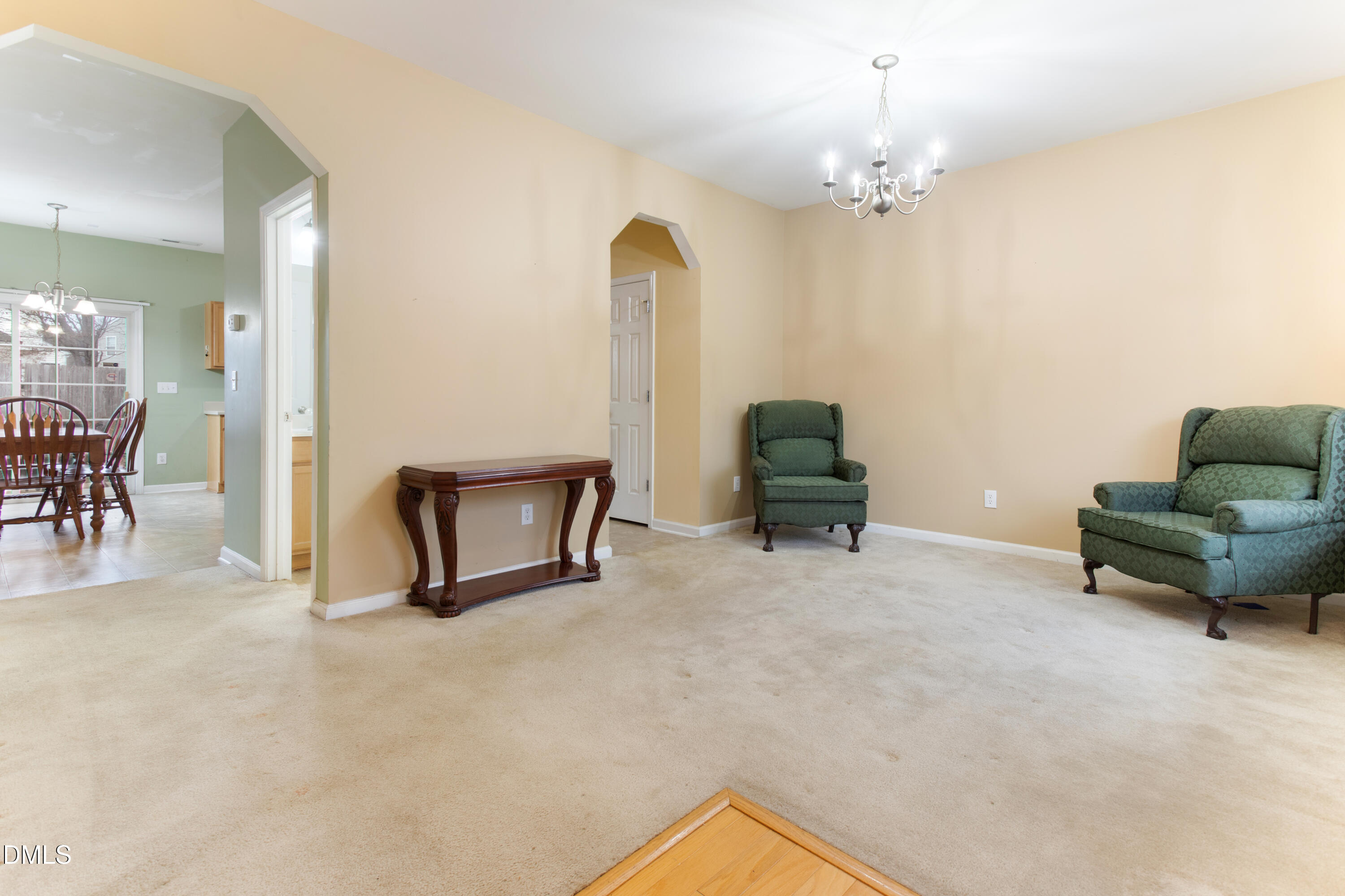 3101 Rendezvous Drive Raleigh, NC 27610 - Photo 18 of 39 a living room with furniture and a chandelier