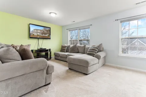 a living room with furniture a couch and a flat screen tv