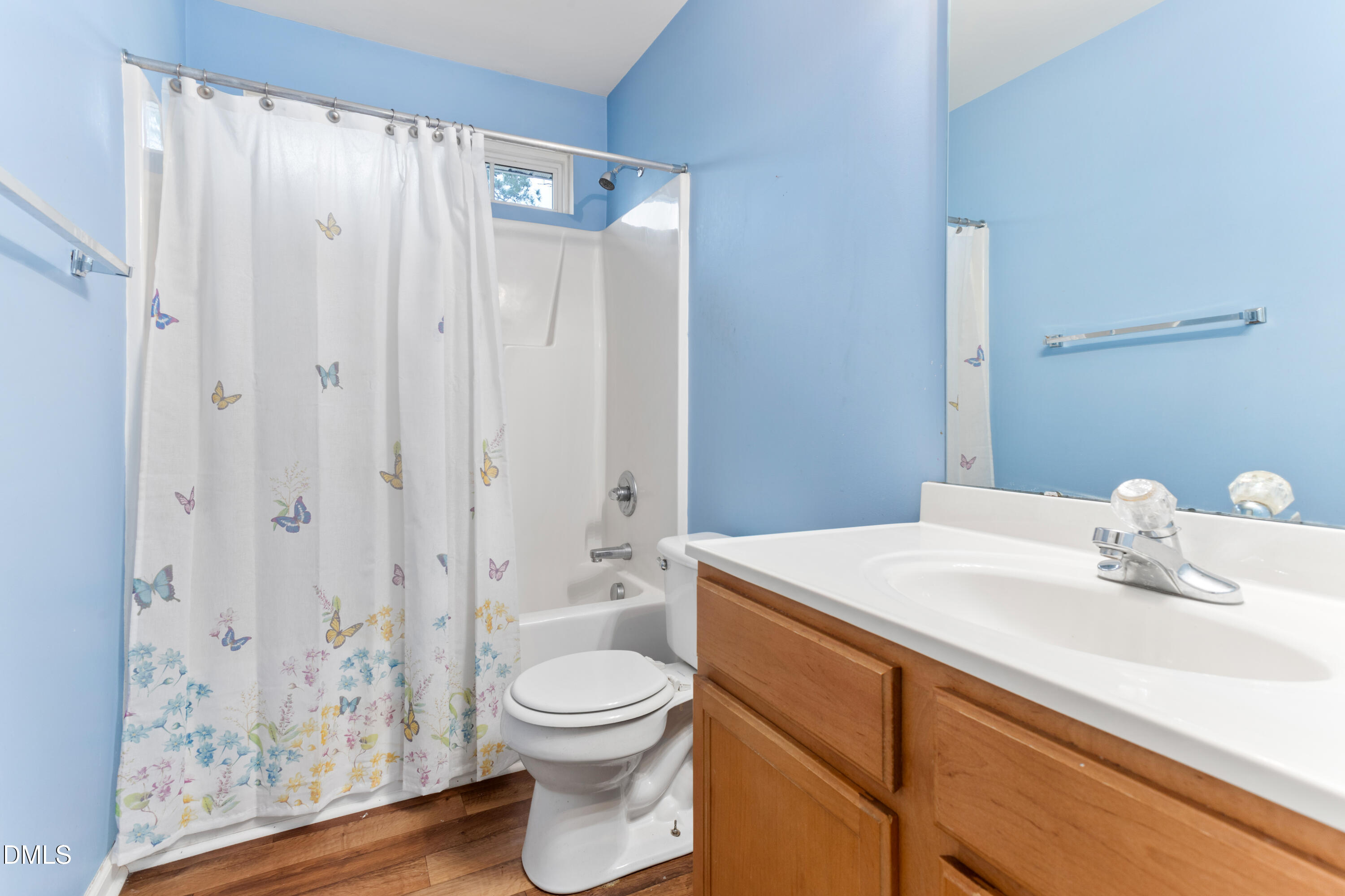 3101 Rendezvous Drive Raleigh, NC 27610 - Photo 23 of 39 a bathroom with a sink a toilet and shower curtain