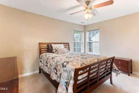 a bedroom with a bed and painting on the wall