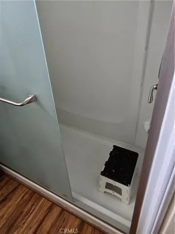 a room with a wooden floor and white walls