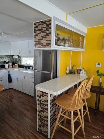 a kitchen with a table chairs and a wooden floor