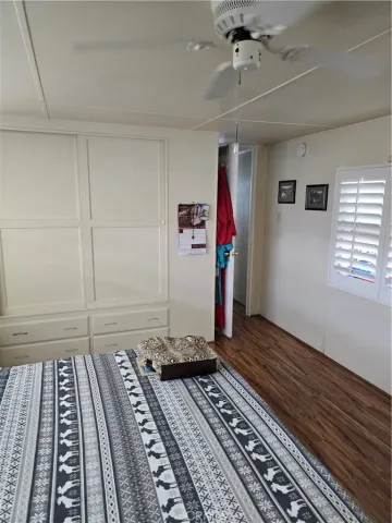 a bedroom with wooden floor