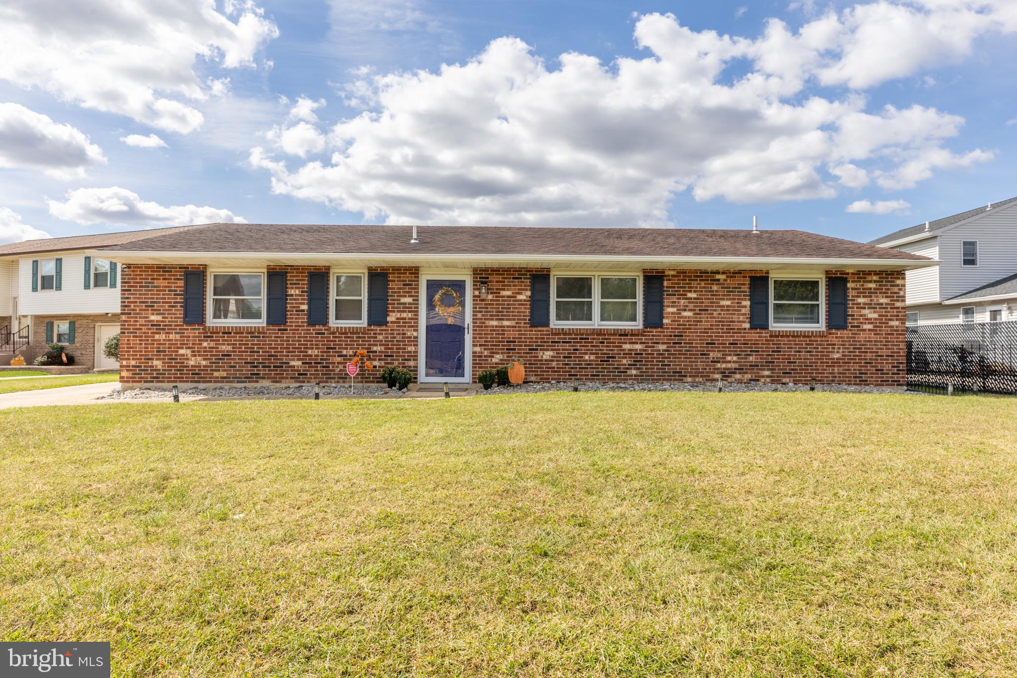 a front view of house with yard and outdoor seating
