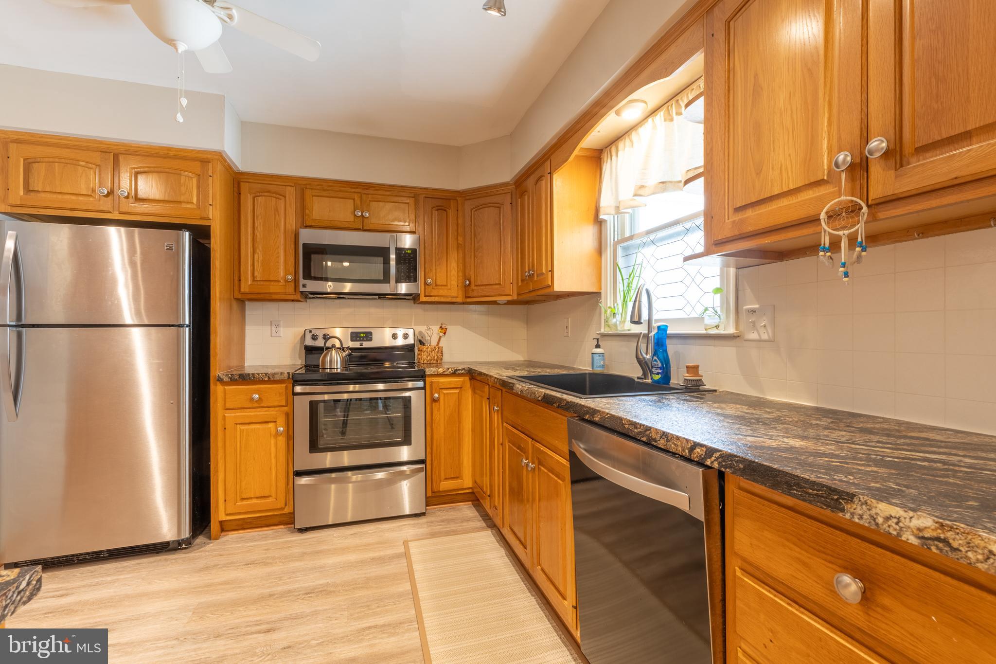 4 Reyburn Court New Castle, DE 19720 - Photo 8 of 21 a kitchen with stainless steel appliances granite countertop a refrigerator a stove and a sink