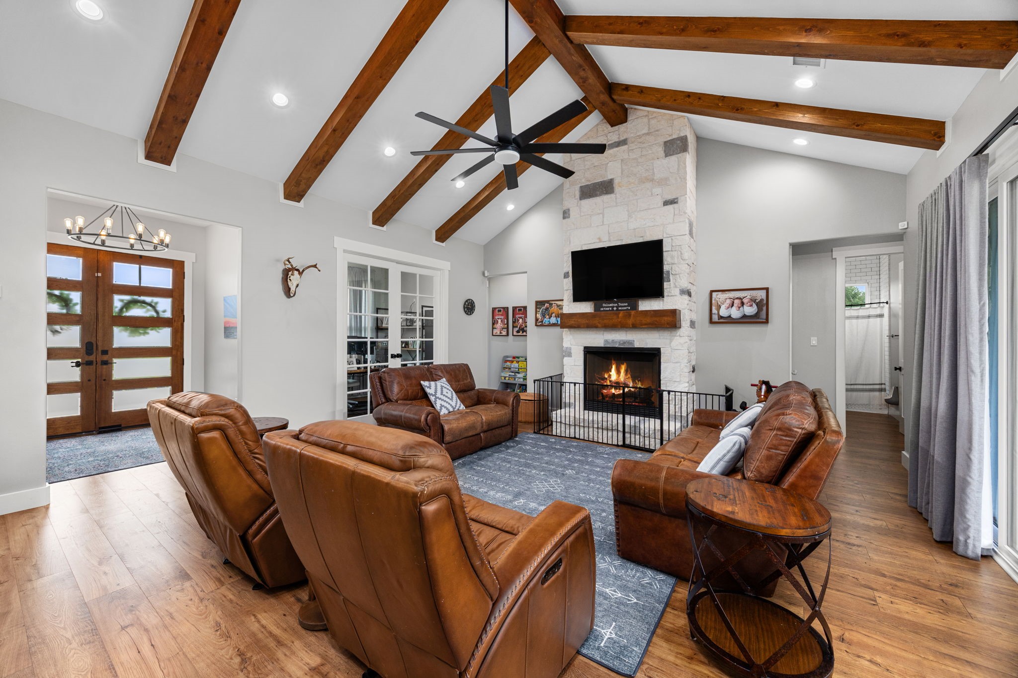 1507 Smith Rau Road Columbus, TX 78934 - Photo 13 of 50 a living room with furniture a flat screen tv and a fireplace