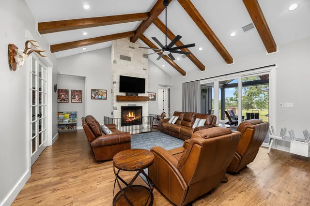a living room with furniture a fireplace and a flat screen tv