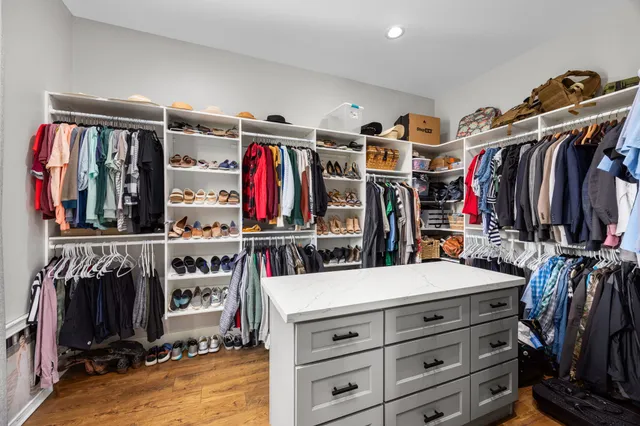a view of walk in closet with clothes